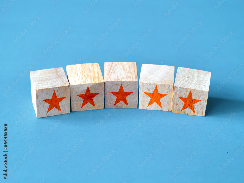 Five stars on wooden block, top quality rating of service or product