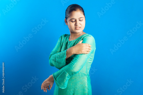 Indian women holding her injured shoulder