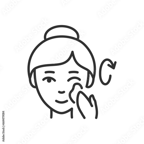 Woman rubs cream over her face in circular motions, linear icon. Line with editable stroke