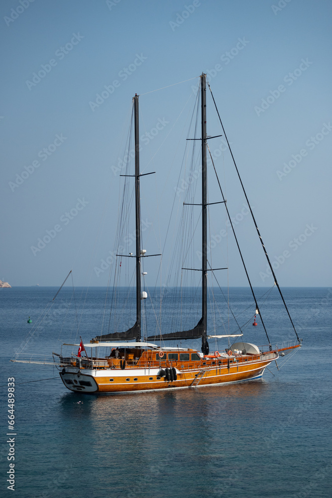 Beautiful wooden sail boat anchored by the coast of Datça, Turkey Beautiful wooden sail boat anchored by the coast of Datça, Turkey
