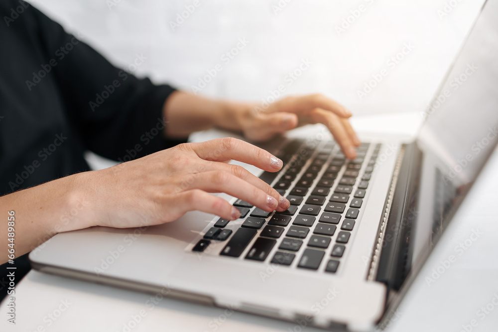 Close up woman's hands typing on laptop keyboard at home office. Businesswoman or student girl using pc for online internet marketing, freelance, work from home, education online, distance studying Close up woman's hands typing on laptop keyboard at home office. Businesswoman or student girl using pc for online internet marketing, freelance, work from home, education online, distance studying
