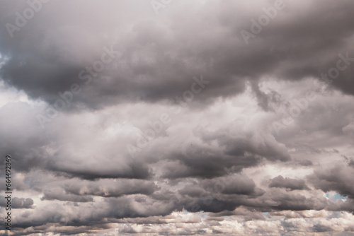 Low gray rain clouds thicken in the sky. The sky before the rain. Fall bad weather, hurricane, dangerous weather conditions, rainy season in October. Abstract natural skyline background. Fresh air.