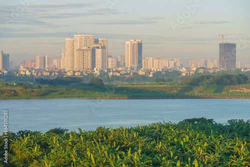 Hanoi skyline cityscape with Red river, banana garden and buildings on background