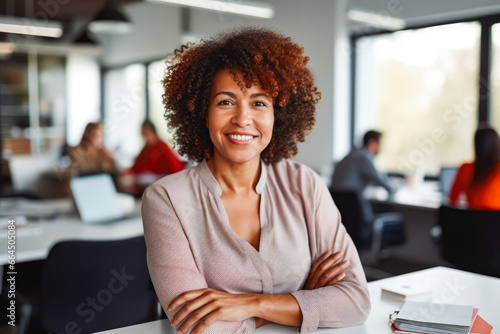 Successful mature afro american woman at meeting in office. Mature confident black business woman in business environment building.