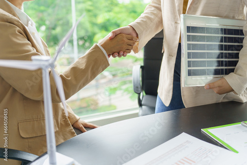 Handshake and business with solar panels green energy Business people working in green eco friendly office business meeting creative ideas for business eco friendly