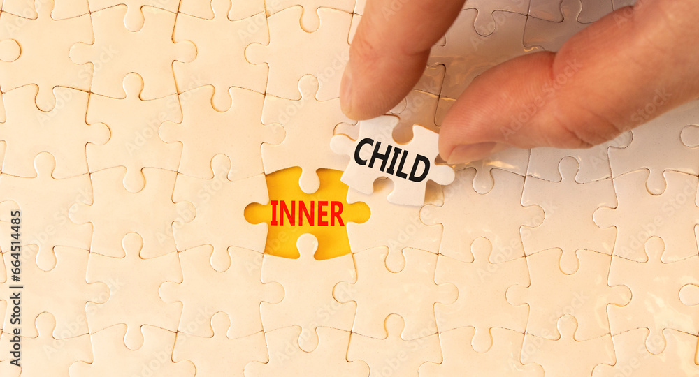 Inner child symbol. Concept words Inner child on beautiful white paper puzzle. Beautiful yellow background. Psychologist hand. Psychological, motivational inner child concept. Copy space. - obrazy, fototapety, plakaty 