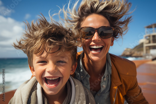 Close-up portrait of a beautiful woman and her son on board a pleasure boat. Cheerful, smiling mother and boy are traveling, enjoying their time. Recreation, travel and entertainment.