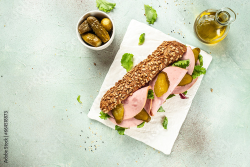 Photography submarine sandwiches with ham and pickled cucumbers on a light background top view