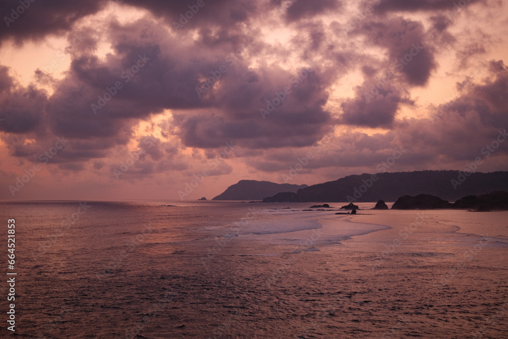 Massive Clouds, Reddish Sea, and Sunset Waves in Lombok's Majestic Serenity