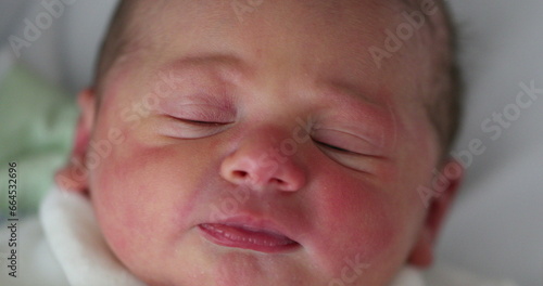 First day of life of newborn infant baby falling asleep