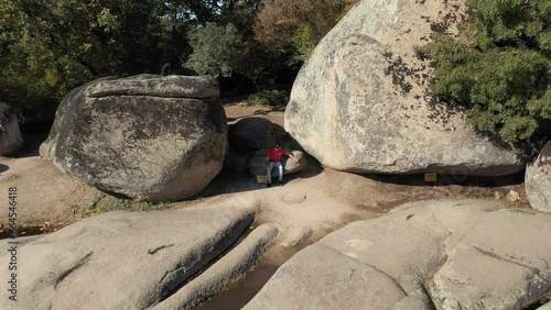 Drone view of a man sitting at Begliktash which is an ancient ruin near the city of Primorsko, Bulgaria. Beglik Tash is a prehistoric rock phenomenon located on the southern coast of the Black Sea. photo