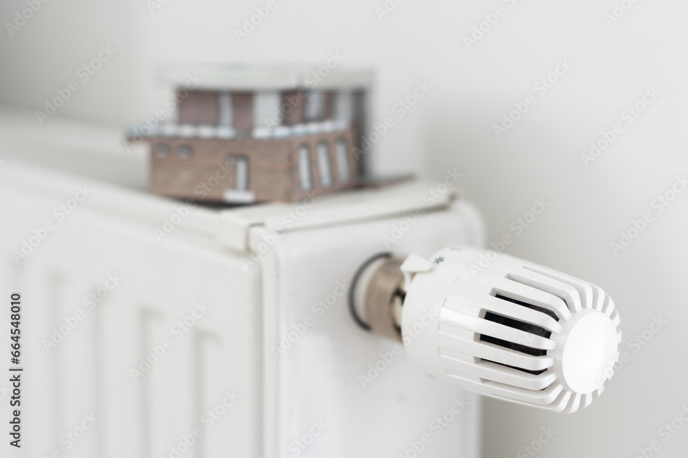 House model on the heating radiator. House model on the heating radiator.