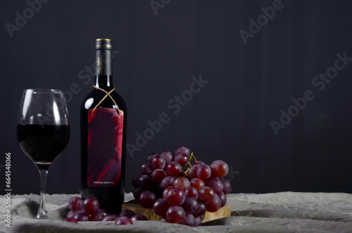 wine bottle with glass and grapes