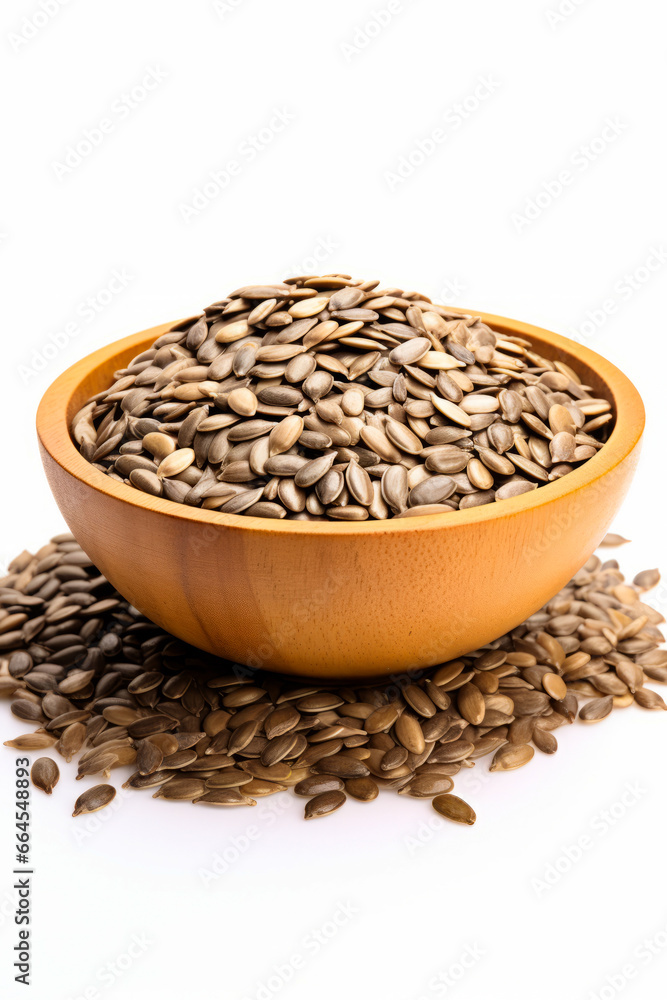 Wooden bowl filled with sunflower seeds on top of white surface. Wooden bowl filled with sunflower seeds on top of white surface.