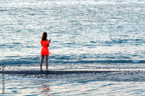 The girl in red by the sea