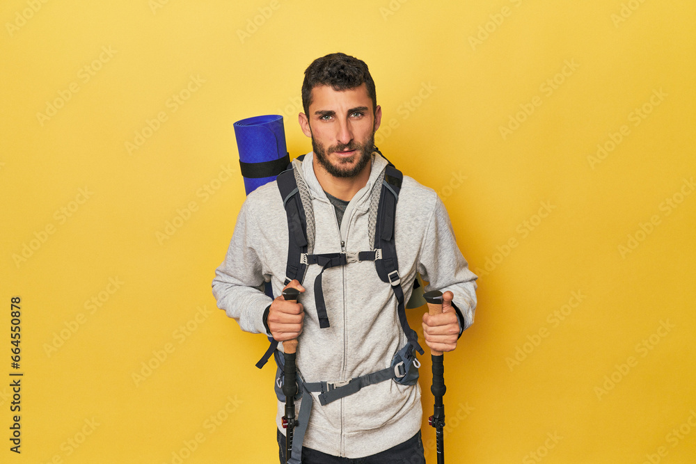 Hispanic man with backpack and hiking poles Hispanic man with backpack and hiking poles