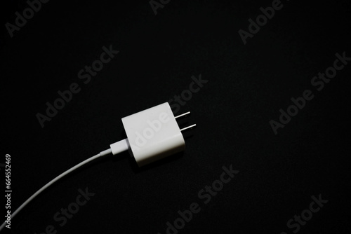 white phone charger with black background