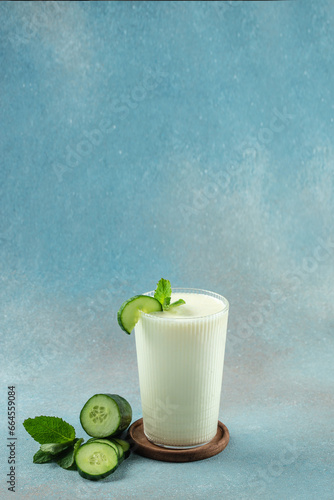Ayran drink with mint and cucumber on a light background, organic healthy products. Detox and clean diet concept