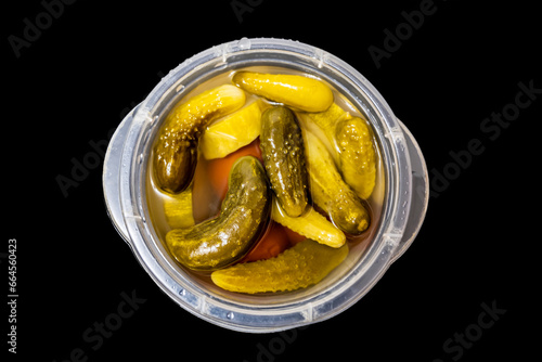Pickles, pickled cucumbers, tomatoes, zucchini. Black background.
