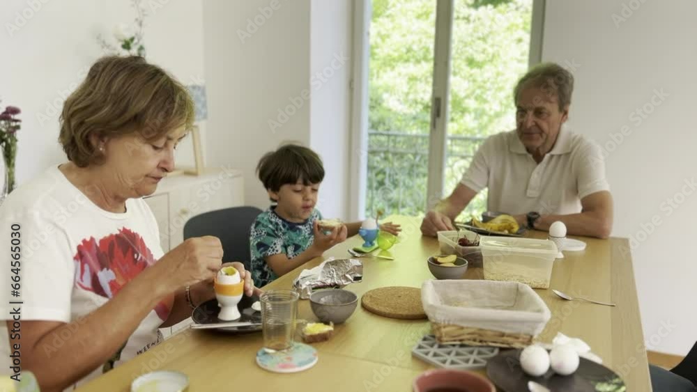 Morning Family Breakfast - Young Boy Enjoys a Healthy Meal with His Grandparents Morning Family Breakfast - Young Boy Enjoys a Healthy Meal with His Grandparents