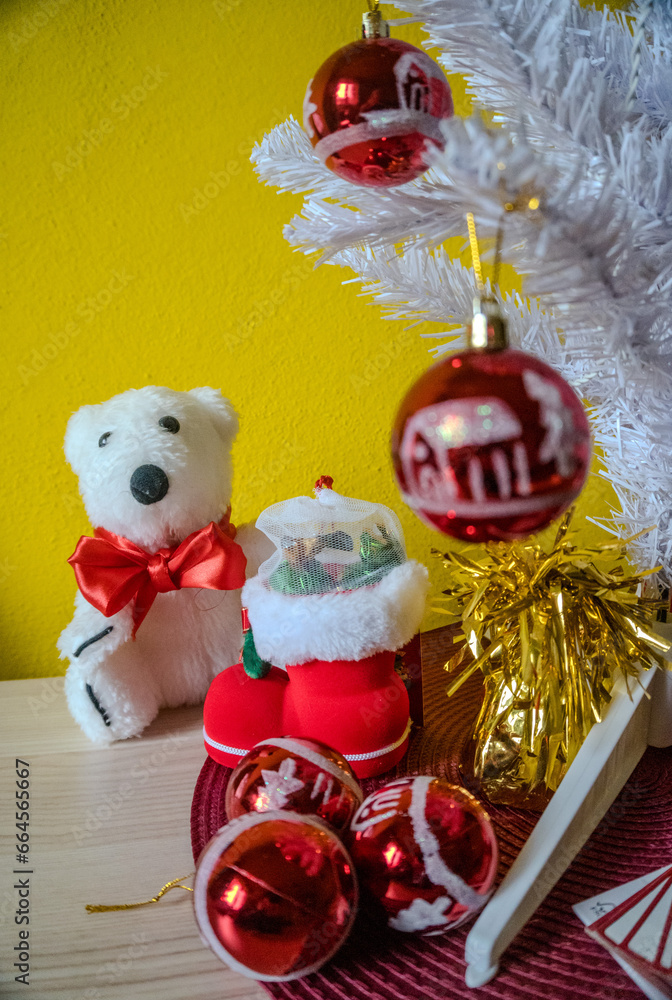 Christmas arrangement, hanging red decorations. Gifts under the Christmas tree.