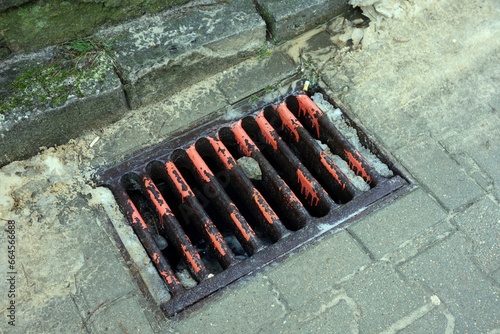 Fototapeta Naklejka Na Ścianę i Meble -  Someone without imagination spilled orange paint down the sewer
