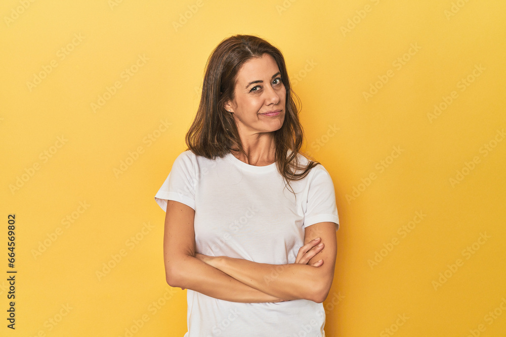 Middle-aged caucasian woman on yellow unhappy looking in camera with sarcastic expression. Middle-aged caucasian woman on yellow unhappy looking in camera with sarcastic expression.