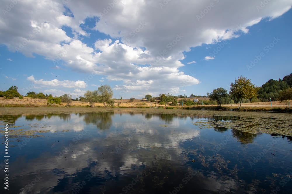 Landscape of the lake with clouds reflected in the water.