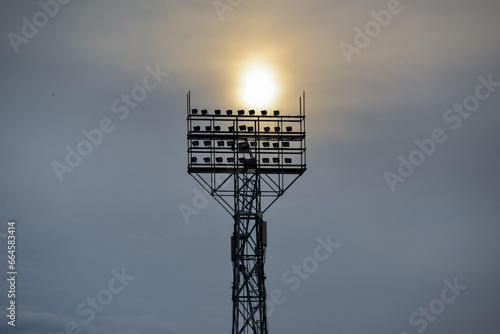 Sport stadium light tower on sunset