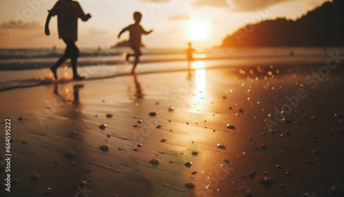 Children playing joyfully on the beach at sunset.