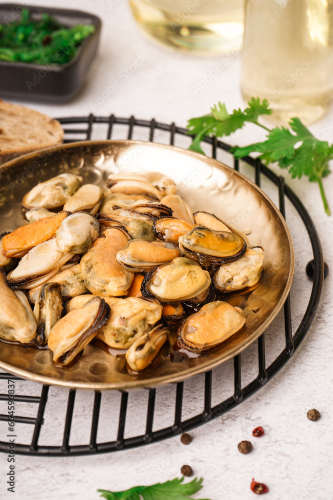 Plate of pickled mussels on grey background Plate of pickled mussels on grey background