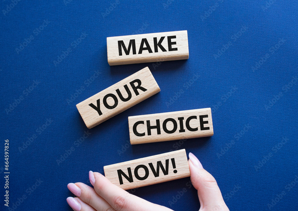 Make your Choice now symbol. Concept words Make your Choice now on wooden blocks. Beautiful deep blue background. Businessman hand. Business and Make your Choice now concept. Copy space.