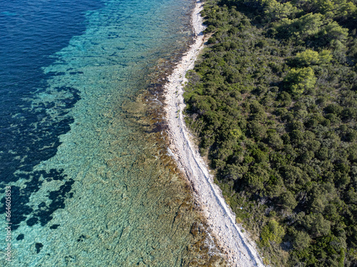 Drone above photo of summer paradise beach between forest and clear blue sea water