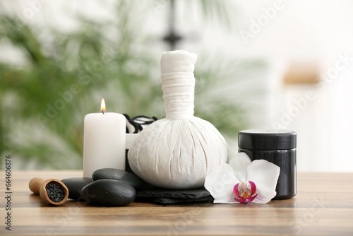 Beautiful spa composition with burning candle on wooden table