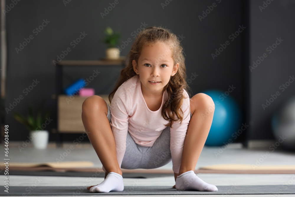 Sporty little girl practicing yoga in gym Sporty little girl practicing yoga in gym
