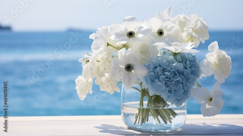 a serene arrangement of blue hydrangeas and white anemones, set against a backdrop of calm, azure waters.