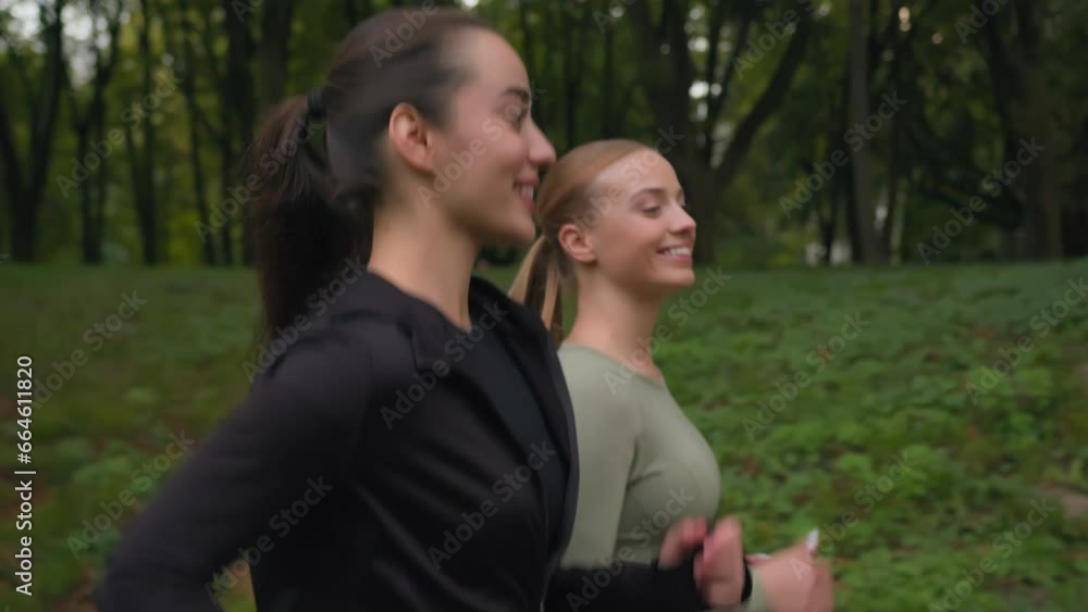 Active fit females runners in sporty outfit running jogging in autumn park outdoors smiling Caucasian girls women sportswomen enjoying cardio sport lifestyle healthy activity run jog workout outside Active fit females runners in sporty outfit running jogging in autumn park outdoors smiling Caucasian girls women sportswomen enjoying cardio sport lifestyle healthy activity run jog workout outside