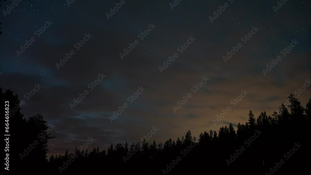 Time lapse of starry sky with passing clouds over forests in Finland Time lapse of starry sky with passing clouds over forests in Finland