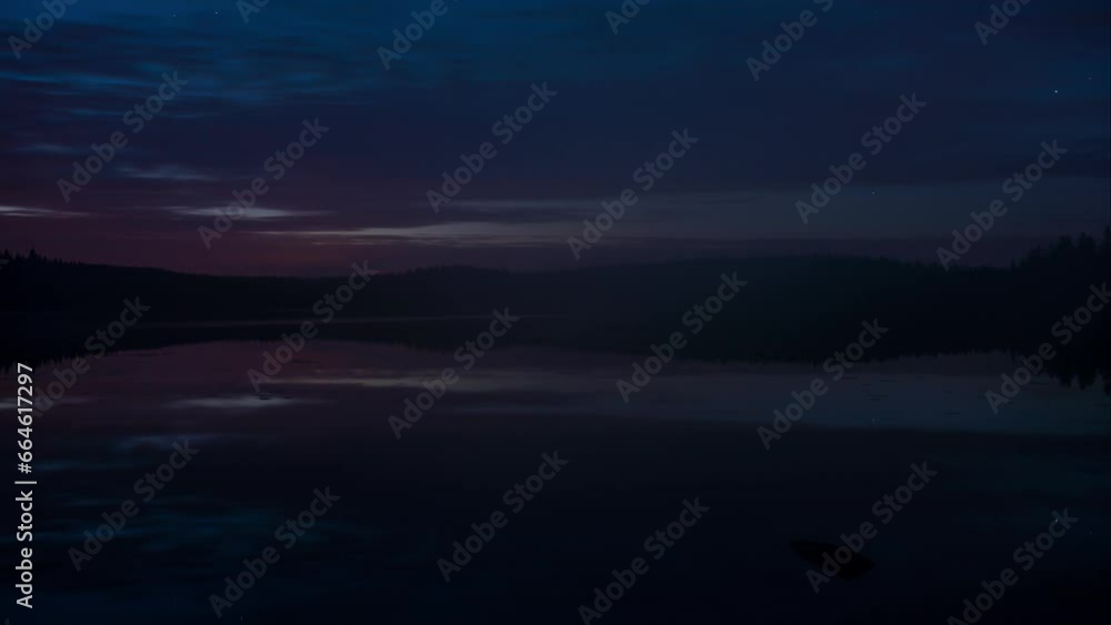 Time lapse of cloud movement reflected on a lake surface in forests in Finland in evening with spreading fog Time lapse of cloud movement reflected on a lake surface in forests in Finland in evening with spreading fog
