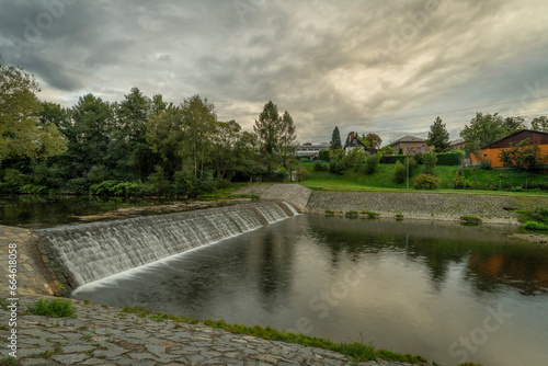 Roznovska Becva river in Valasske Mezirici in autumn cloudy evening photo