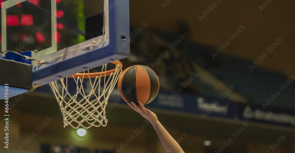 close-up of a hand clapping a basketball
