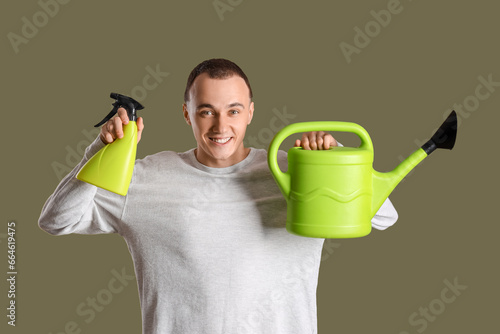 Young man with spray bottle...