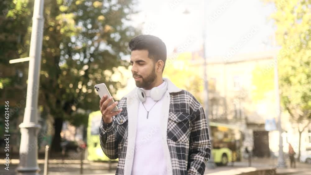 Portrait of young handsome stylish man hold smartphone scrolling social media texting browsing online at urban city Attractive guy relax enjoying great day and looking at screen at street outdoors Portrait of young handsome stylish man hold smartphone scrolling social media texting browsing online at urban city Attractive guy relax enjoying great day and looking at screen at street outdoors