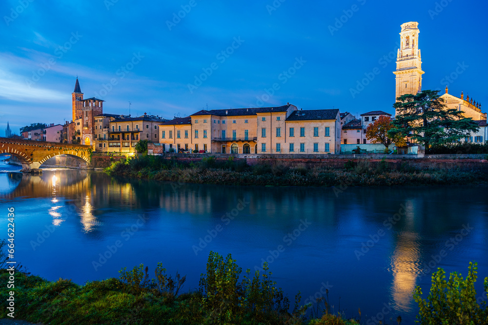 Verona, Veneto, Italy: Twilight view of Agige river waterfront with the Cathedral of St. Mary and the Stone Bridge and tower