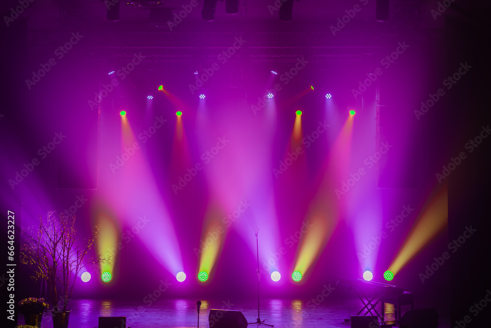 Empty stage lit up in various lights
