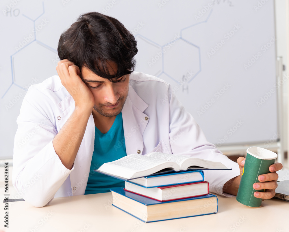 Young student chemist in the classroom Young student chemist in the classroom