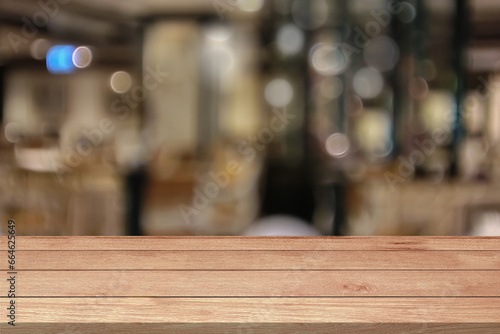 Empty wooden table top or counter on coffee shop cafe or restaurant blur bokeh defocused template mock up display montages product. Wood table plank lights for products display blurry background