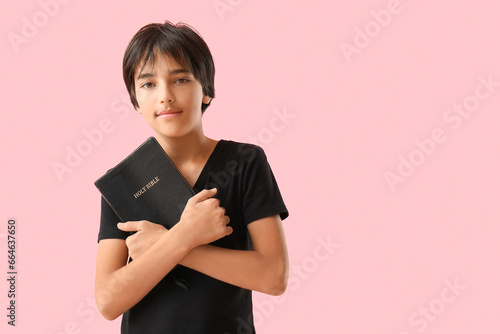 Little boy with Bible on pi...