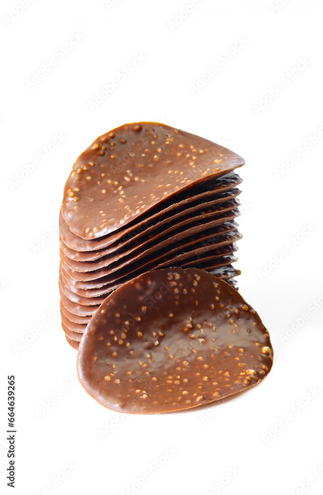 Stack of thin chocolate covered chips isolated on white background Stack of thin chocolate covered chips isolated on white background