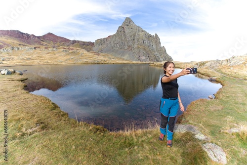 Latin girl taking a selfie in a mountain lake. in the French Pyrenees